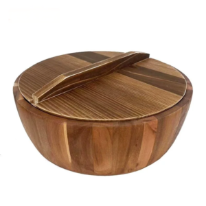 A huge wooden centerpiece bowl filled with fresh apples and citrus fruits on an open kitchen island