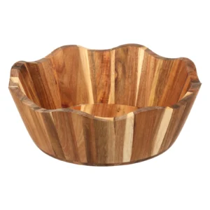 Large salad bowl wooden with decorative scalloped rim styled on a rustic farm table