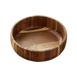 Thickened deep acacia wood salad bowl piled high with fresh organic apples and oranges on a rustic kitchen island